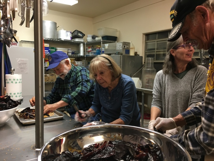 (l-r) Lion George Grubb (Charter Member, almost 34 years!), Lion Alice Hack, Lion Heather Williamson and Lion Bob Gray clean chiles.